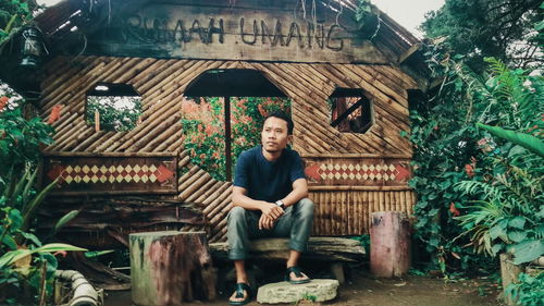 Portrait of young man sitting outdoors