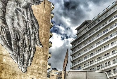 Low angle view of building against cloudy sky