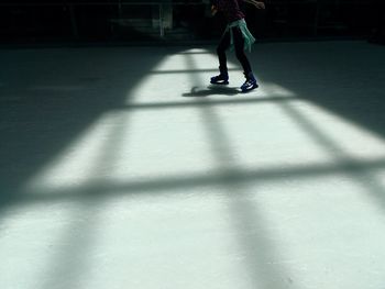 Low section of woman ice-skating