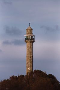 Low angle view of lighthouse against building