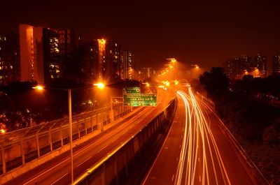 High angle view of light trails on two lane highway during night