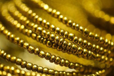 Close-up of golden jewelries on table