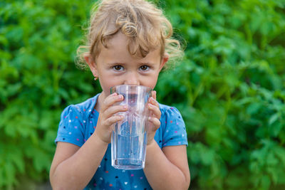 Young woman drinking water from bottle