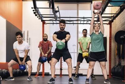 Group of beginners athletes exercising in a personal class with a private trainer. various exercises