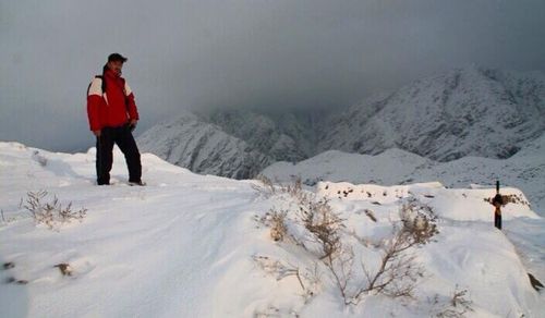 Man standing on snowcapped mountain