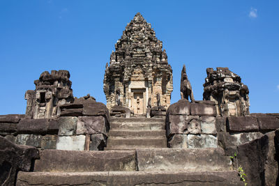 Low angle view of historic temple against clear blue sky