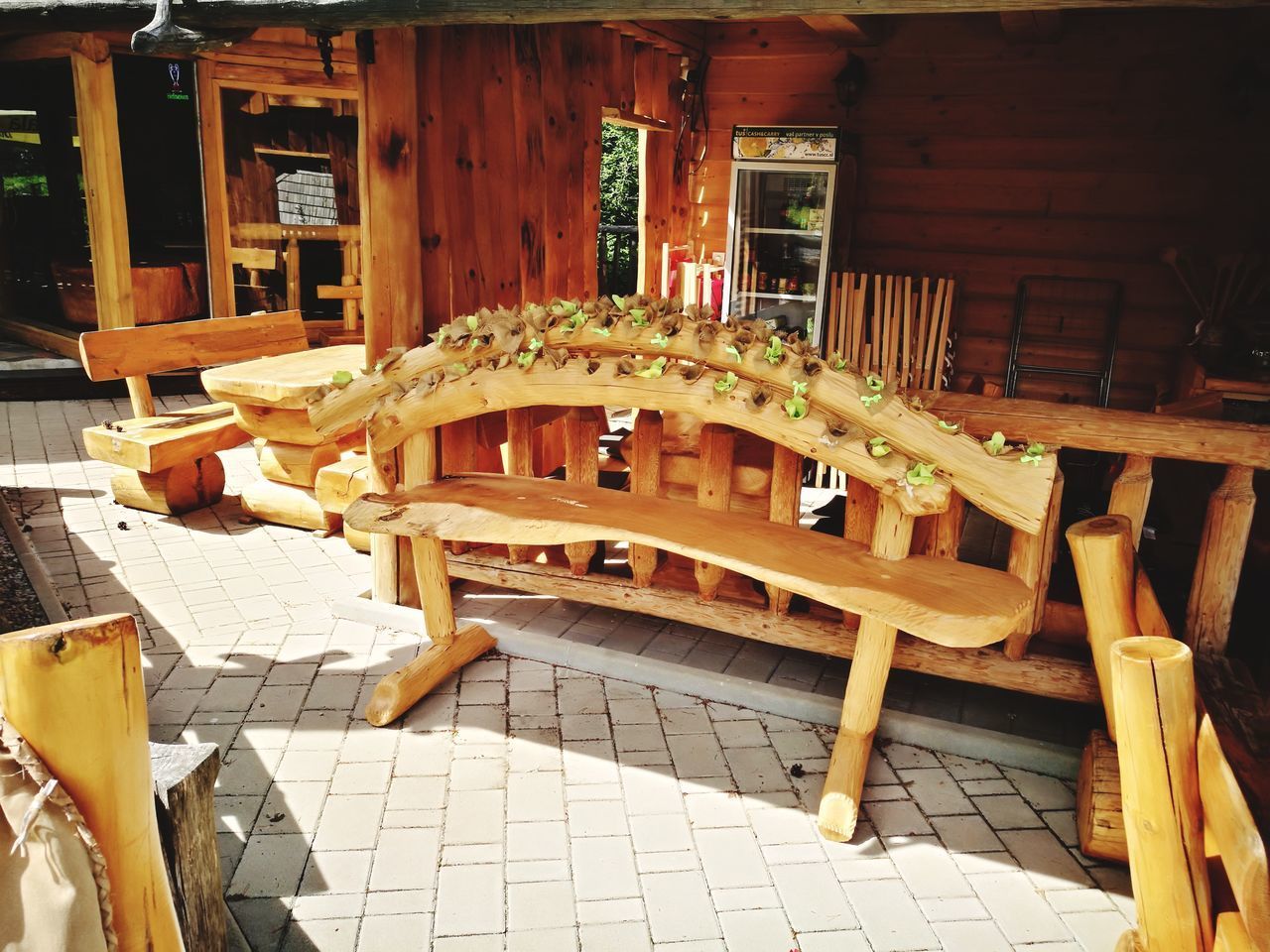 EMPTY CHAIRS AND TABLES AT SIDEWALK CAFE BY BUILDING