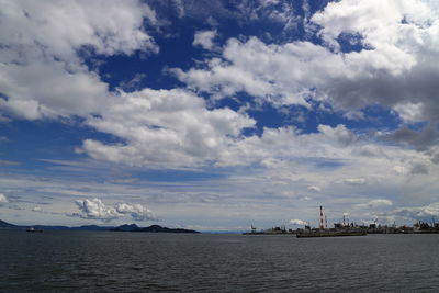 Scenic view of sea by buildings against sky