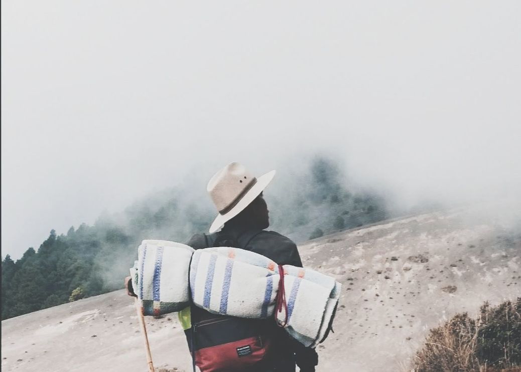 fog, one person, mountain, nature, day, sky, real people, scenics - nature, non-urban scene, activity, transportation, rear view, beauty in nature, hiking, clothing, hat, lifestyles, leisure activity, outdoors