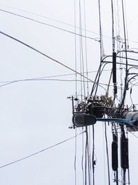 Directly below view of street light on electricity pylon against clear sky