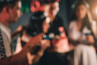 Defocused image of people enjoying at night