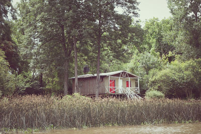 Built structure on field against trees in forest