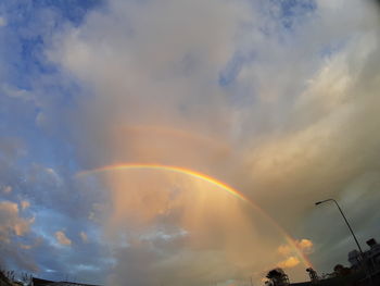 Low angle view of rainbow against sky at sunset