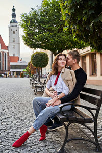 Portrait of happy woman sitting in city