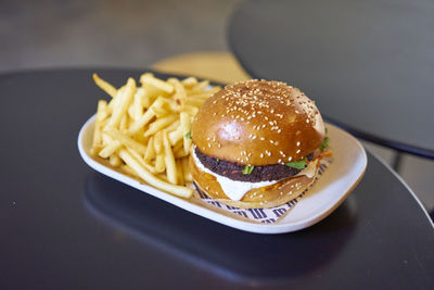 Burger and french fries in tray on table