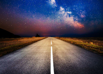 Road against sky at night