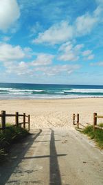 Scenic view of beach against sky on sunny day