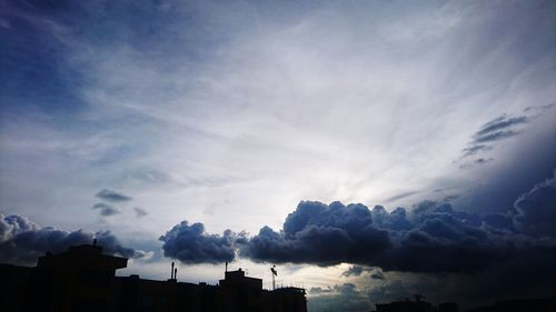 Low angle view of building against cloudy sky