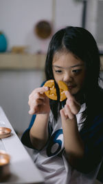 Young woman eating cookies