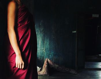 Rear view of woman standing at home