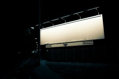 Illuminated empty road at night