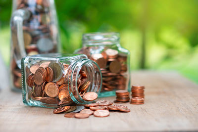 Close-up of coins in jar on table