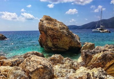 Rocks by sea against sky