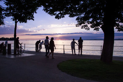 Silhouette man in sea at sunset