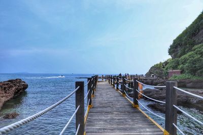 Pier over sea against sky