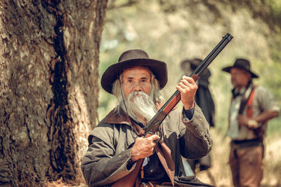 Portrait of man holding rifle 