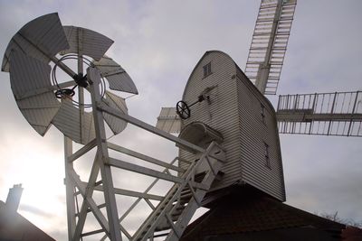 Low angle view of traditional windmill against sky