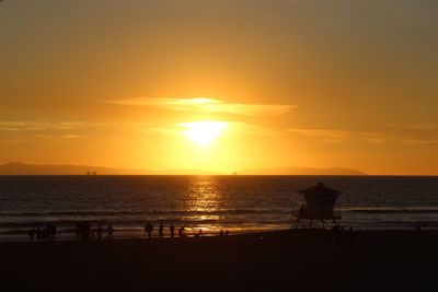 Scenic view of sea against orange sky