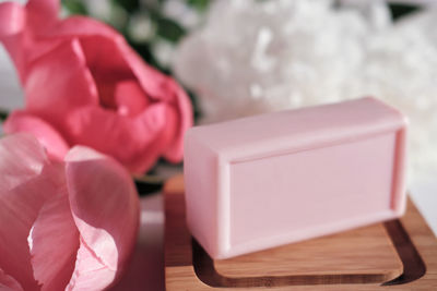 Close-up of pink rose on table