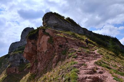 Low angle view of rock formations against sky