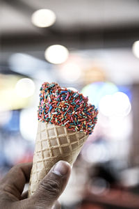 Close-up of hand holding ice cream cone