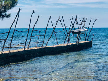 Fishing boat in sea against sky