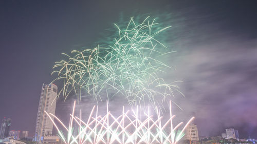 Low angle view of firework display at night