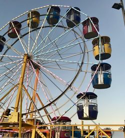 Low angle view of ferris wheel against sky