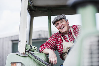 Portrait of smiling farmer on tractor