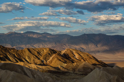 Scenic view of mountains against cloudy sky