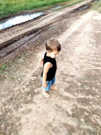 High angle view of boy walking on land