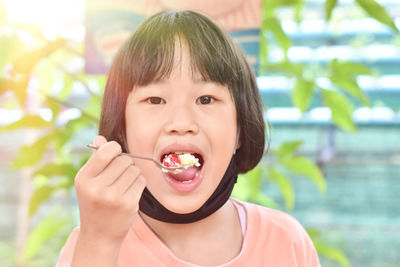 Portrait of boy eating food