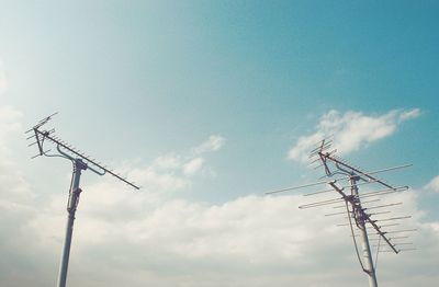 Low angle view of telephone pole against sky