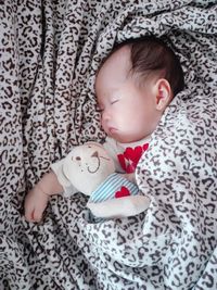 Cute baby girl lying on bed