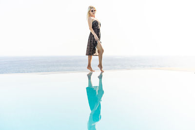 Full length of woman standing at beach