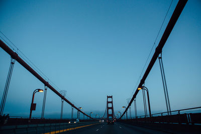 Low angle view of golden gate bridge against clear blue sky