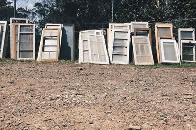 Low angle view of window frames against fence