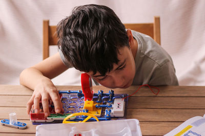 Child boy collects electronic constructor. educational toys. development of preschool children