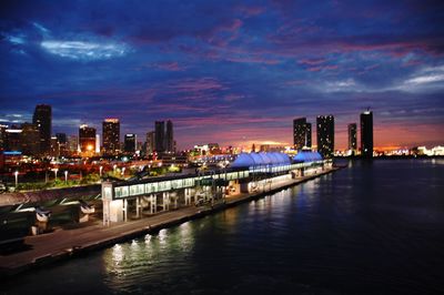 View of city at waterfront at night