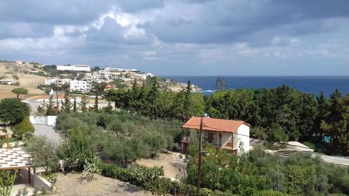 High angle view of townscape by sea against sky